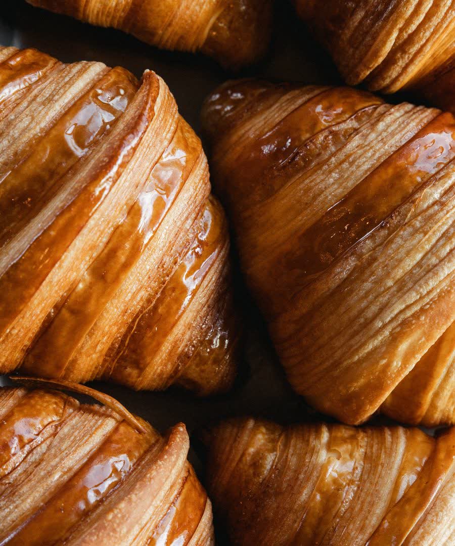 A tray of butter croissants, freshly baked.