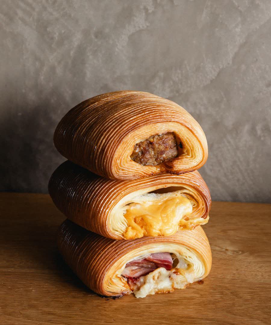 Ham and cheese cruffins stacked three high.